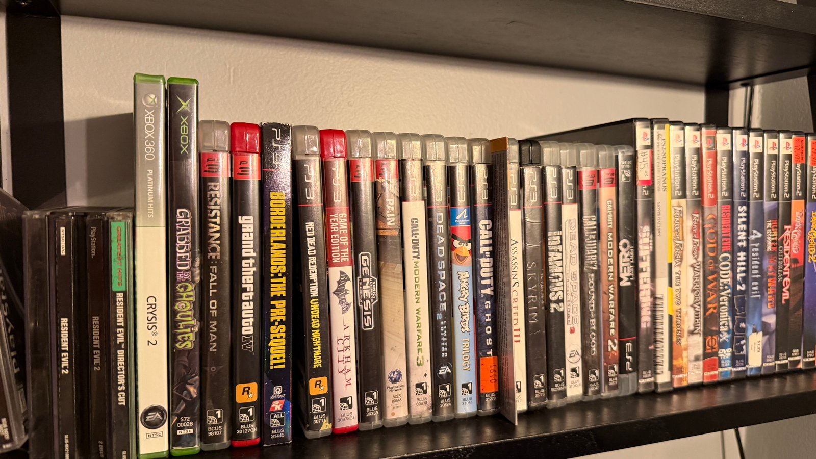 Shelf row of PS2 and PS3 games